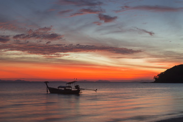 Fototapeta na wymiar Boat on ocean sunrise 
