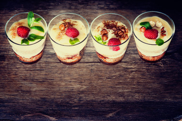 Dessert with berries, jelly, cream, nuts and mint leaf 