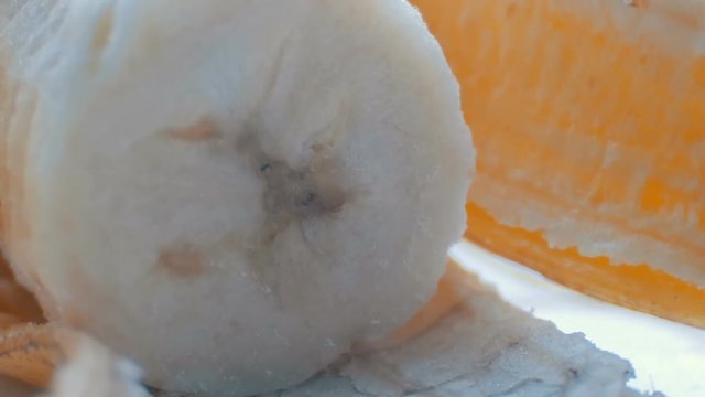 Body banana with the peel on a white background macro close up view