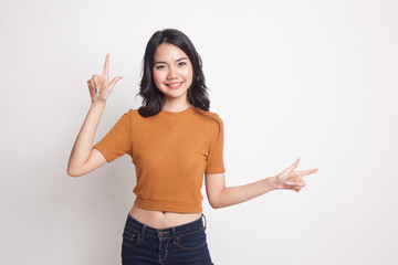 Young Asian woman point with two hands.
