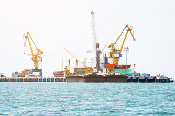 Shipping port, Crane shipping goods into cargo ship at port cargo for logistic import export in...