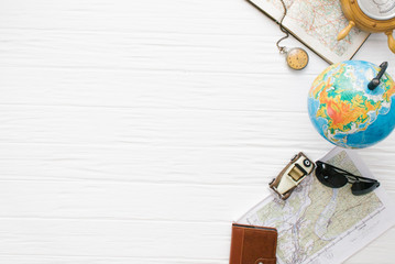 Traveler accessories still life on a white wooden background