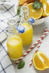 orange juice in bottles and oranges.