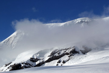 Fototapeta na wymiar Winter landscape with snow-capped peaks of the Caucasus mountains, the highest peak in Europe-mount Elbrus, Russia