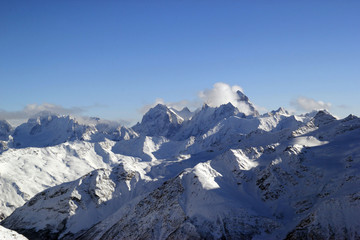 Winter landscape with snow covered peaks of Caucasus mountains, view from Elbrus mountain, Russia