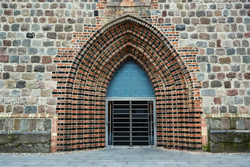 A medieval portal of a Gothic church in the city of Neuebrandemburg in Germany.