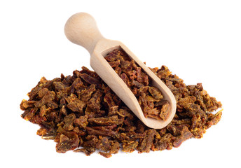 Propolis granules in a wooden shovel are isolated on a white background. Bee glue. Bee products....