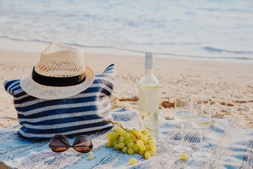 Picnic background with bag, grape and white wine by blue sea