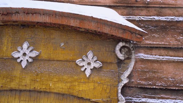 Cold Siberian winter wooden old house details. Unique authentic Russian style wood carving architecture. Irkutsk center tourist attraction. White snow wind blizzard. Gimbal professional 4k