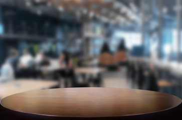 Selected focus empty brown wooden table and Coffee shop or restaurant blur background with bokeh image. for your photomontage or product display.