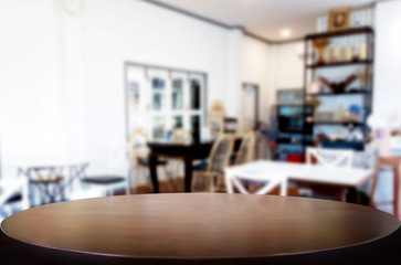 Selected focus empty brown wooden table and Coffee shop or restaurant blur background with bokeh image. for your photomontage or product display.