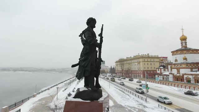 Aerial drone around Monument To The Founders Of The City Of Irkutsk. Russian Cyberia conqueror men weapon. Important tourist place. Winter frozen cold weather.