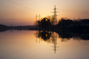 Sunset landscape. Pond at sunset time. Evening color of sky.