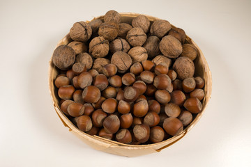 Walnuts and hazelnuts in a wicker basket.
