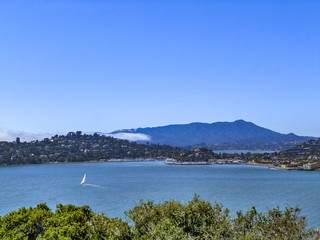 Skyline of Angel Island in San Francisco with sailboat and houses summer landscape
