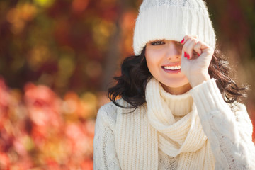 Young beautiful woman at autumn background. Portrait of attractive young girl outdoors