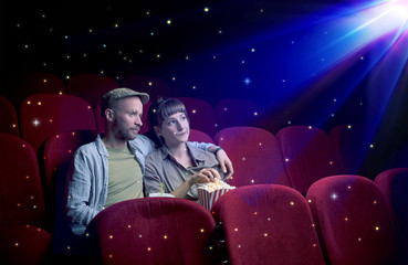 Naklejka premium Lovely couple watching 3D movie with little sparkling stars around