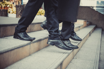 Fototapeta premium defocused or blured Businessman walking the stairs with city background, Businessmen go to success concept, vintage style.