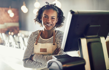 Smiling waitress standing by an order terminal in a restaurant