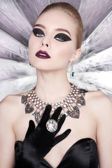 Woman with bright makeup and with set jewelry