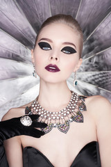 Woman with bright makeup and with set jewelry