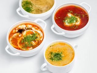 Variety of soups, restaurant hot dishes, healthy food isolated at white. Top view.