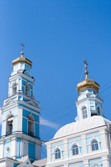 Bell tower and Golden domes with crosses of the blue and white Church of the Ascension in Yekaterinburg in Russia.