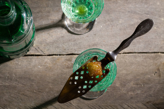 Burned sugar on spoon, traditional method served of absinthe.