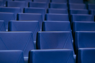 Many rows of empty armchairs. Blue, elite seats, comfortable armchairs. Conference room, theater or cinema.