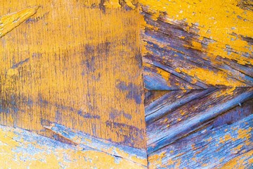 Texture of old wooden surface with spots of yellow paint