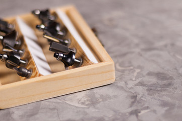 Set of steel router bit for milling cutter in rectangle wooden box with metal lock on old broken...