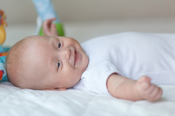Bright portrait of a sweet little 4 months old newborn baby boy