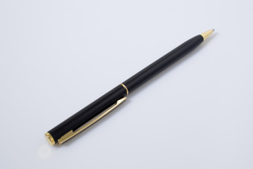Black and gold pen in a white background