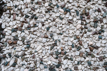 Wall with small stones as texture background.
