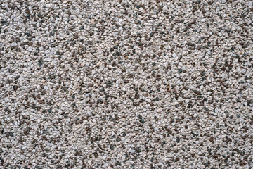 Wall with small stones as texture background.