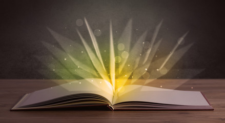 Yellow lights spreading from an open book 