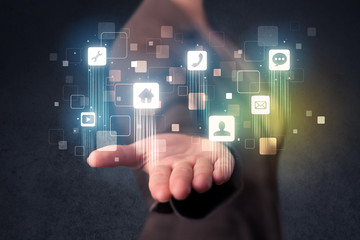 Blue social application icons in the hands of young casual businesswoman