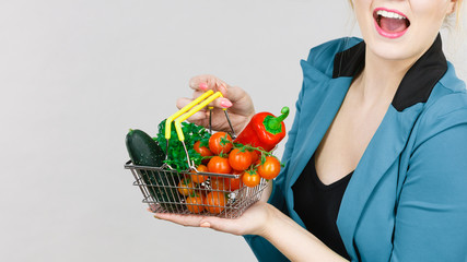 Obraz na płótnie Canvas Woman holds shopping basket with vegetables