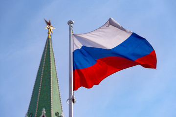 Naklejka na ściany i meble Russian flag and blue sky over Kremlin in Moscow