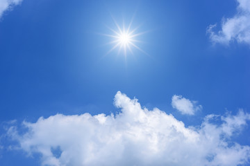 Naklejka na ściany i meble Sun with sunlight in white clouds on blue sky.