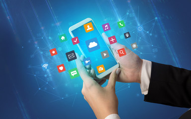 Female hand using smartphone with colorful application icons around