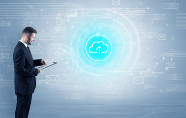 Standing businessman with data around and highlighted icon on the centre
