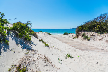Sand dune and turquoise water in Alghero