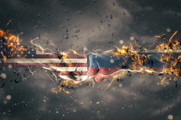 Two fists hitting each other over dramatic sky background. USA and Russia conflict concept. Fire illustration.