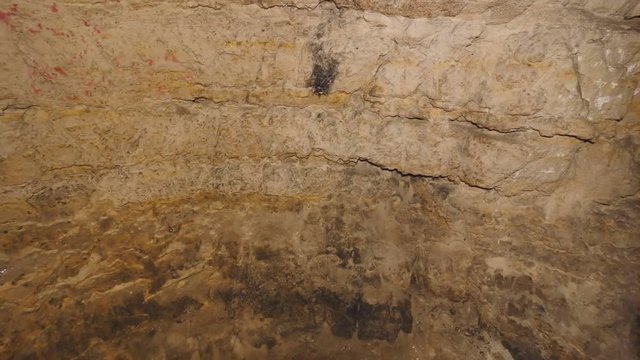 Walk through underground tunnel built in soft sandstone rock. Underground shelter for persecuted persons. Horrible wet odor.