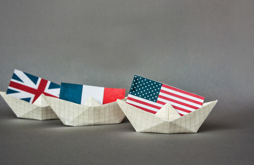 paper ship with Flags of US,France, Great Britain and Russia. conflict in Syria sea, concept shipment or free trade agreement and membership. grunge image 