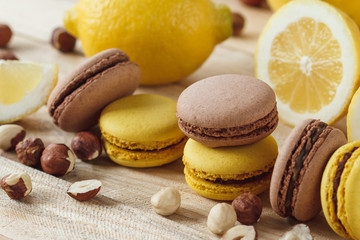 Yellow and brown french macarons with lemon and hazelnuts