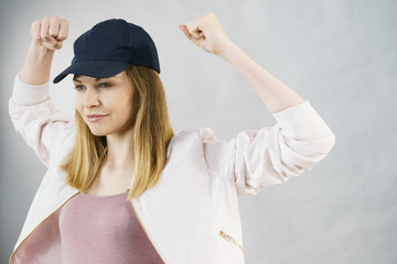 Young woman showing her arm muscles