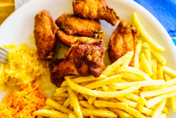 Chicken wings, french fries and salad