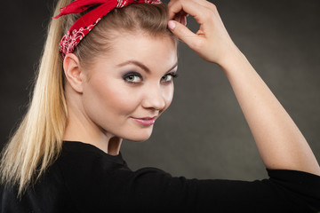 Portrait of retro pin up girl in red handkerchief.